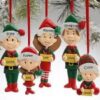 Family-themed Christmas elf ornaments hanging on tree.