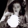 Woman gazing at glowing crystal ball.