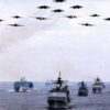 Ships and aircraft in military formation.