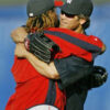 Two baseball players hugging on the field.
