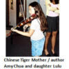 Girl practicing violin with woman watching.