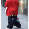 Person wearing sagging pants and red shirt.