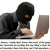 Person in mask typing on laptop.
