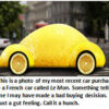 Yellow lemon-shaped car on street.