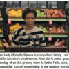 Woman speaking at grocery store produce section.