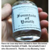 Bottle labeled "Fountain of Youth" in hand.