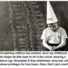 Child in dunce cap beside chalkboard writing.