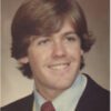 Smiling young man in formal attire.