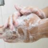Hands washing with soap and water.